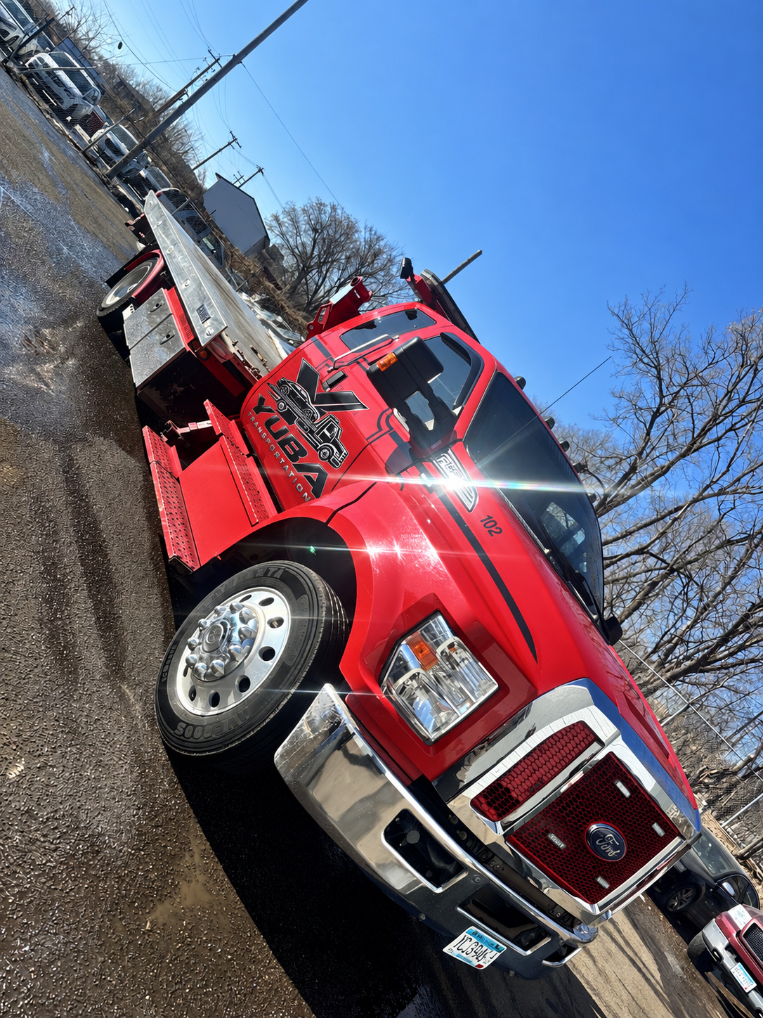 Yuba Transportation's red Ford flatbed truck