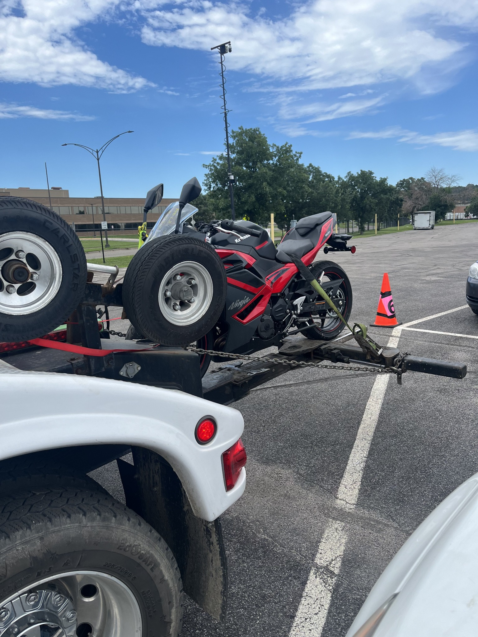 Motorcycle secured on towing equipment for transport